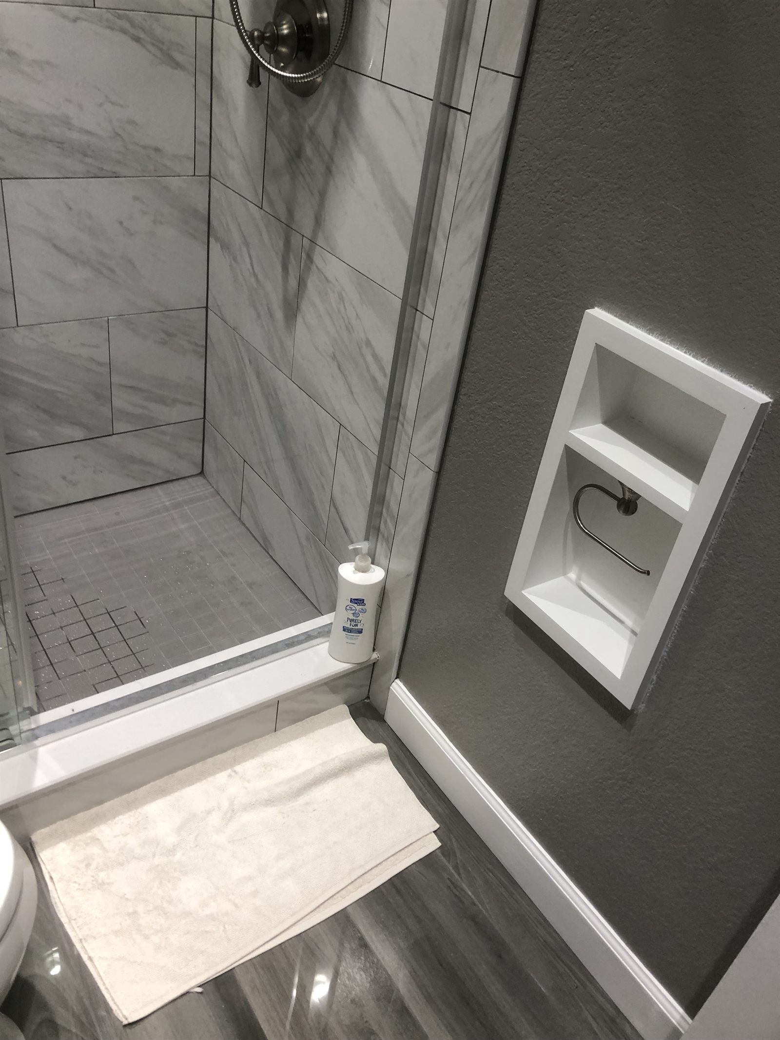 Marble-tile shower with custom recessed niche